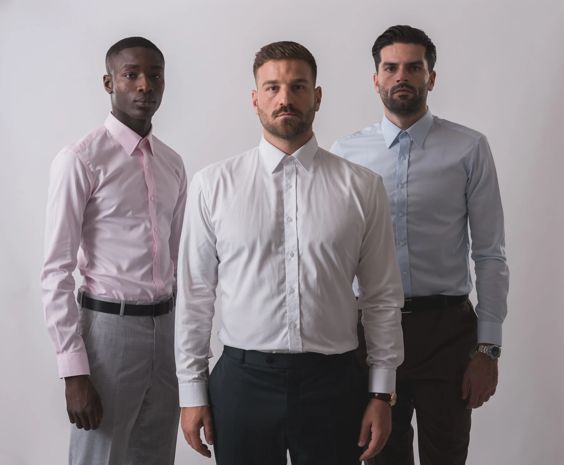 Three models in NIJO pink, white and pale blue shirts