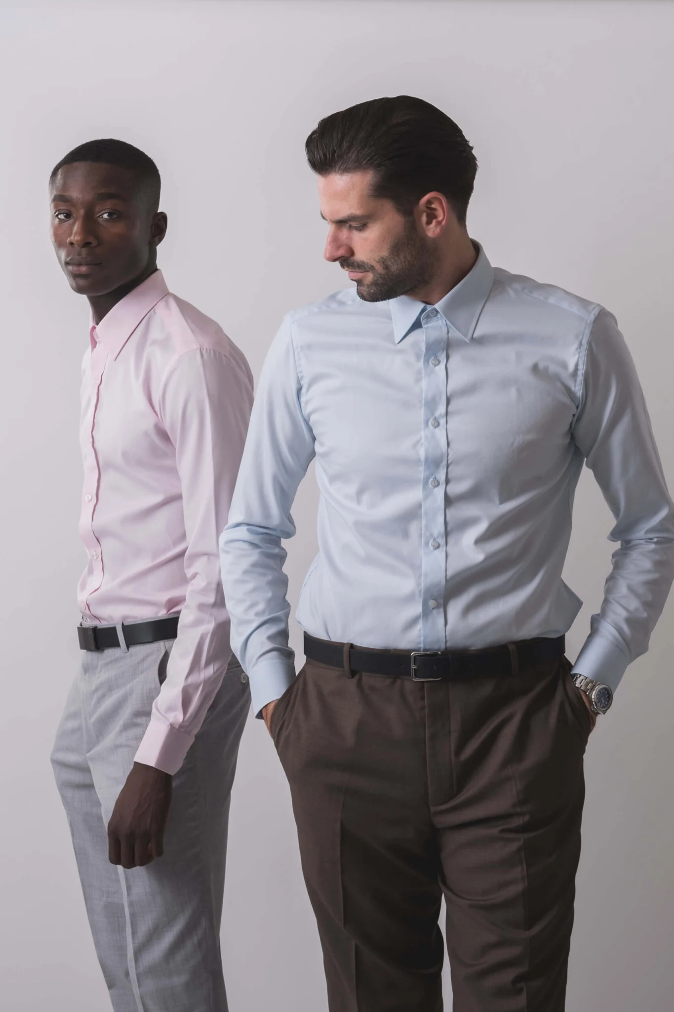 Two models wearing NIJO pale blue and pink shirts