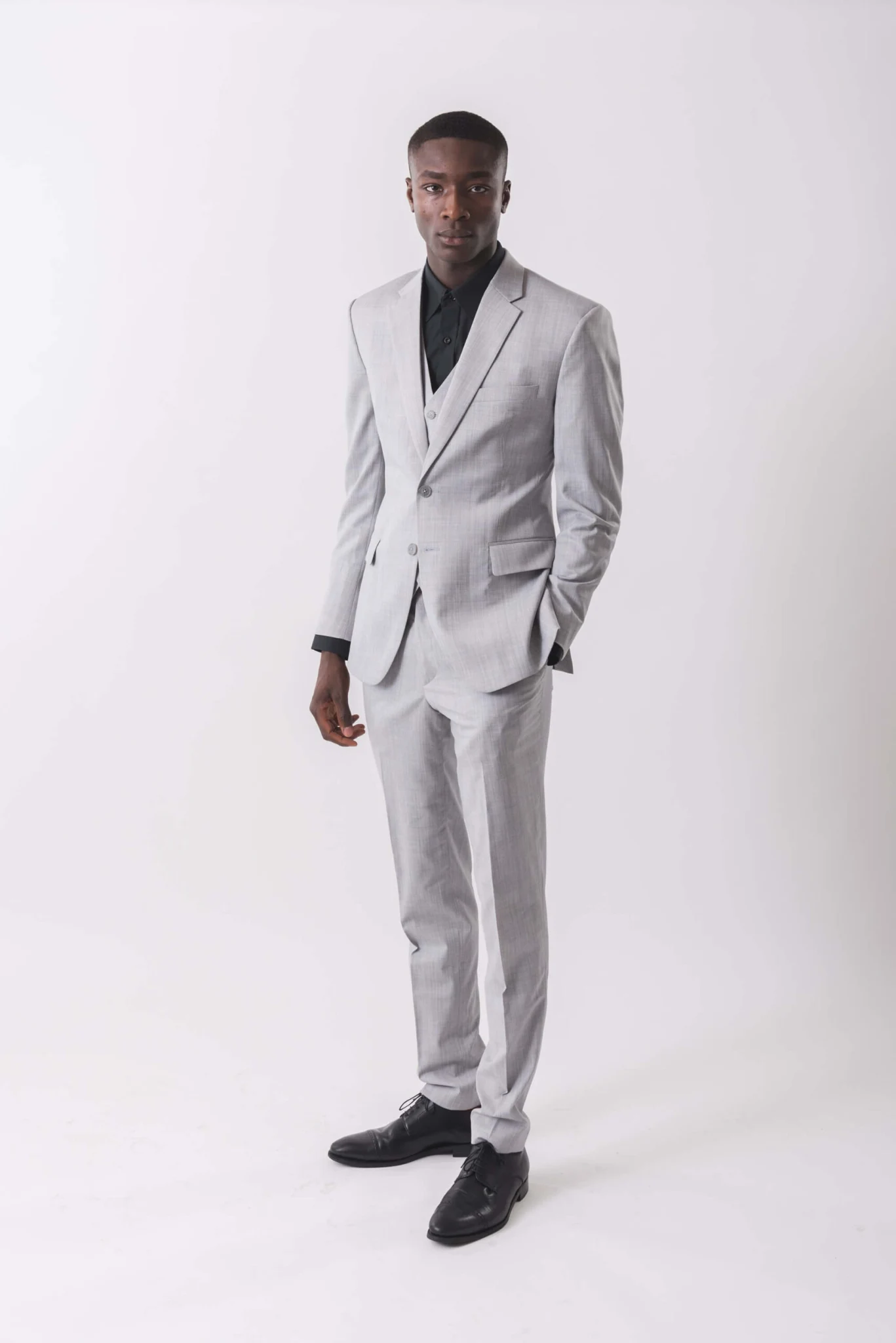 NIJO light grey three-piece suit with a dark shirt